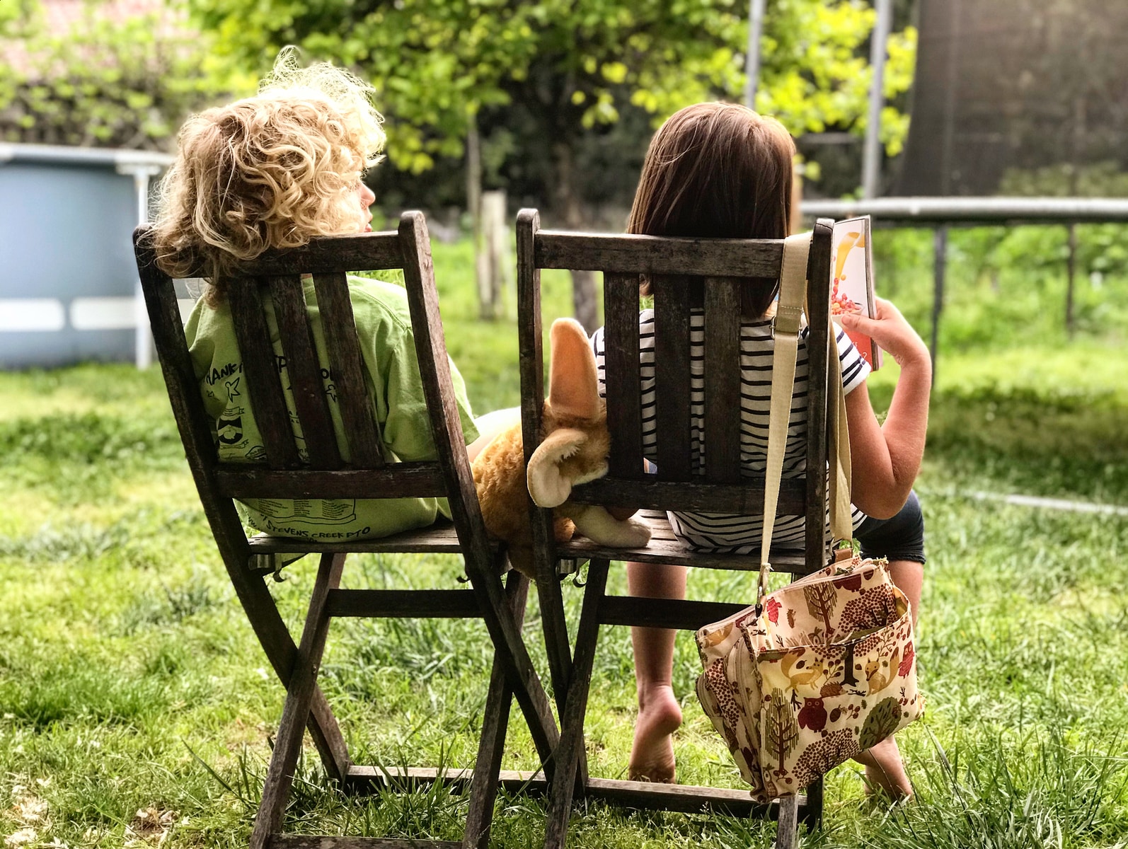 two children sitting on chairs