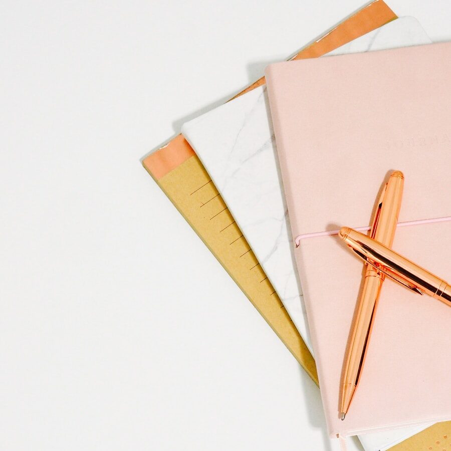 ballpoint pens on pink notebook