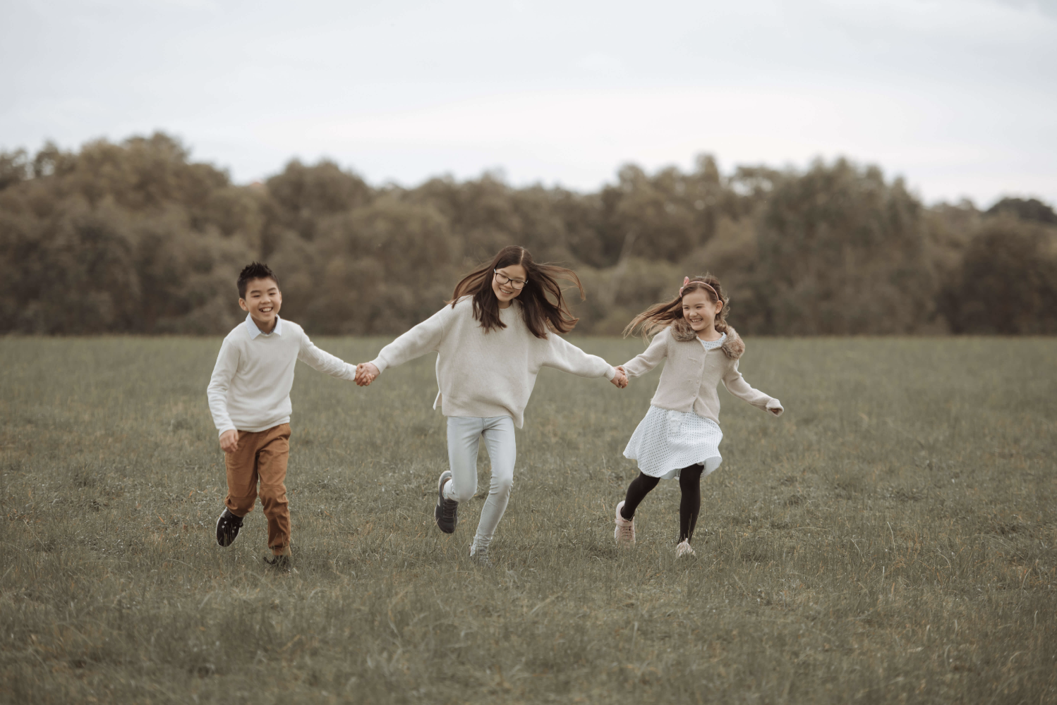 3 children running smiling